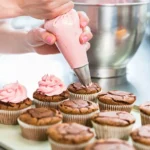 Assorted piping nozzles including round, star, and petal tips for decorating desserts.